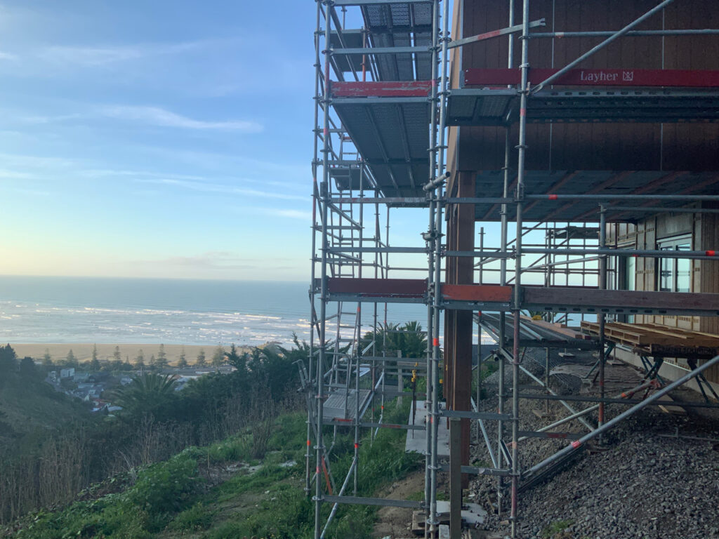 Home under construction showing scaffolding and the view of the ocean
