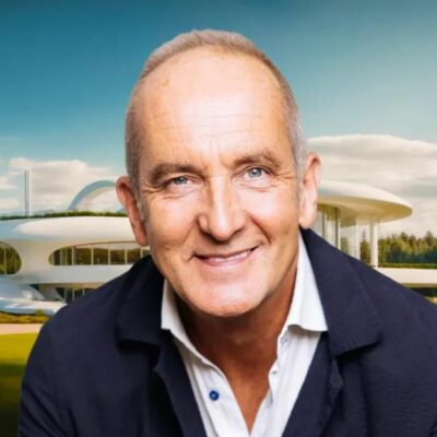 Kevin McCloud in front of futuristic home